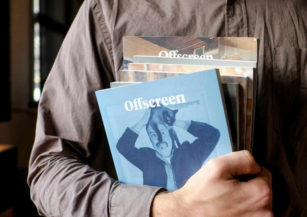 Hands holding a magazine open with some nice typography visible.